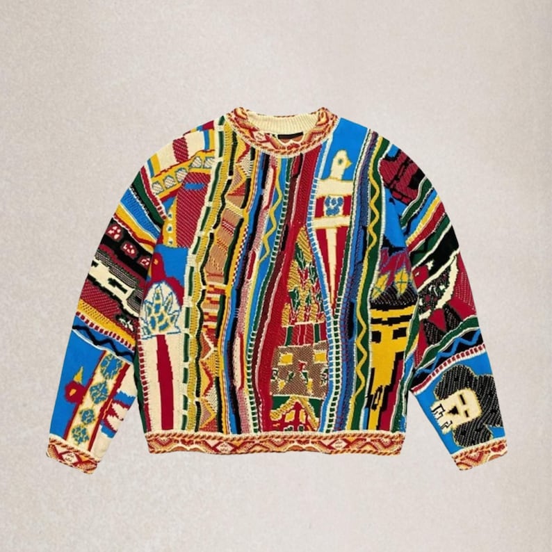 May include: A vibrant, patterned jumper with a crew neck. The jumper showcases a patchwork design with diverse geometric and abstract shapes in red, blue, yellow, and green. The cuffs and hem have a patterned border.