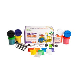 May include: A deluxe Squishy Circuits kit with colorful modeling dough, electronic components, and tools. The kit includes a box with the words "squishy circuits" and illustrations of a car, elephant, and giraffe. The kit also includes containers of dough in various colors.