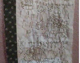 May include: A white fabric sampler with brown embroidery. The embroidery includes the words "Laundry Day" and numbers 1 through 7. The sampler also includes the alphabet and a design of a house with a fence.