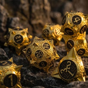 May include: Gold-colored, multi-sided dice with black numbering, resting on a bed of rocks. The dice have a detailed, ornate design. The image includes the text "S09" in the upper left corner.