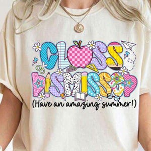 Op de afbeelding: Crèmekleurig T-shirt met een kleurrijke afbeelding met de tekst "CLASS DISMISSED" in een speels lettertype. Het ontwerp bevat een appel, schaar en bloemen. De tekst "(Have an amazing summer!)" staat onder de hoofdtekst.