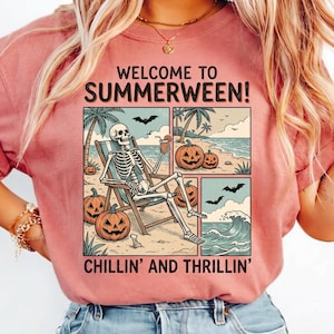May include: A coral-colored t-shirt with the words "WELCOME TO SUMMERWEEN!" above a graphic of a skeleton relaxing on a beach with pumpkins and bats. The text "CHILLIN' AND THRILLIN'" is below the graphic.