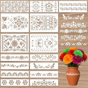 May include: A collection of white rectangular stencils featuring various floral, leaf, and geometric border patterns, displayed alongside a terracotta-colored vase filled with a vibrant bouquet of artificial red, orange, pink, and green carnations.