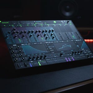 May include: A black synthesizer with numerous knobs, sliders, and a display screen. The synthesizer has green and blue accents, with the word "SERUM" visible. It sits on a dark surface, suggesting a studio setting.