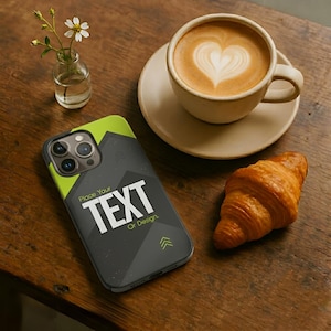 May include: A smartphone case with a geometric design and the text "Place Your TEXT Or Design." A cup of coffee with latte art, a croissant, and a small vase with flowers are on a wooden table.