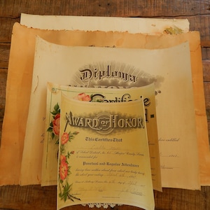 May include: A vintage certificate of honor with floral accents and the text "Award of Honor - This Certifies That Luella M. Major Wendy, Kansas, for Punctual and Regular Attendance having been with us each day of the school year ending May 21, 1912, is hereby entitled to this certificate of honor."
