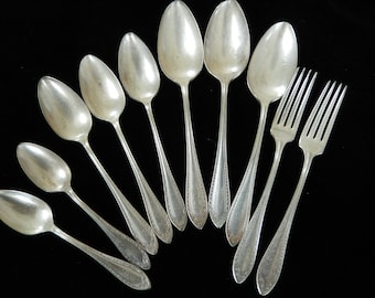 May include: A set of ten silver-plated spoons and forks. The spoons have a rounded bowl and a long, slender handle. The forks have four tines and a similar handle.