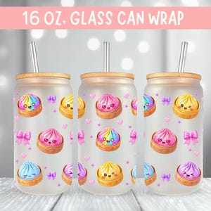 May include: Frosted glass can wrap with a bamboo lid and straw. The design features colorful cartoon dumplings, pink bows, and hearts. The text "16 oz. Glass Can Wrap" is at the top.