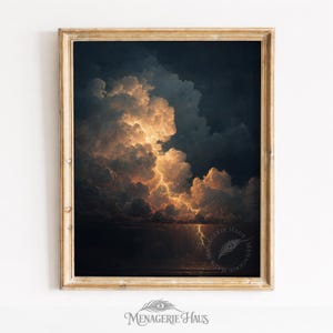 May include: Framed art print depicting a dramatic storm scene. The artwork features dark, ominous clouds illuminated by flashes of lightning. The golden-hued light contrasts with the deep blues and blacks, creating a striking visual effect. The print is in a gold-colored frame.