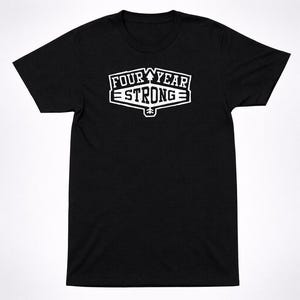 Puede incluir: Camiseta negra con la inscripción blanca "FOUR YEAR STRONG" en un diseño estilizado, que incluye una montaña y un árbol. La camiseta tiene cuello redondo y mangas cortas. Prenda de vestir informal.
