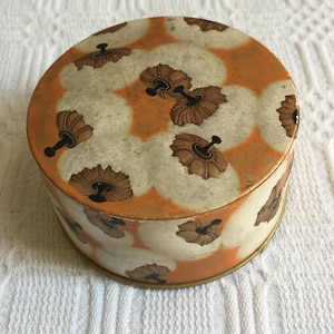 Vintage French Coty Powder Box Picturing Handled Powder Puffs in Black, Gold and White on Orange.  Natural Rachel and Rose Mentioned.