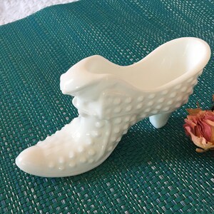 Vintage White Glass Fenton Shoe Vase. Sleeping Lion Draped Over Front of Boot Shoe Vase. Hobnail Designs Covering the Shoe. Hold Lipstick.