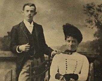 Victorian Tintype of Victorian Man and Woman in Fancy Clothes. Woman in Fingerless Gloves, Rings and Hat. Man With Ring and Watch Chain.