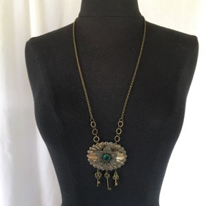 Vintage Brooch Remade Into a Necklace. Green Rhinestone Centers Flower in Antiqued Gold Layered Pin With Three Tiny Dangling Keys.