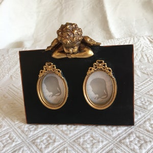 Victorian Reproduction Double Picture frame With Charming Cupid Relaxing On Top of Frame. Deep Set Oval Frames, Black Back Velvet.