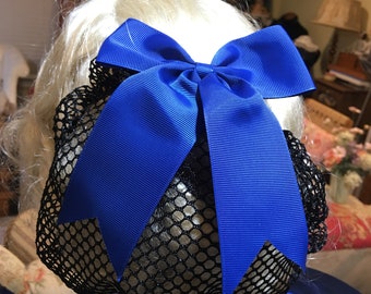 May include: A blue satin bow hair clip with a black mesh bun cover. The bow is tied in a large, classic bow shape.
