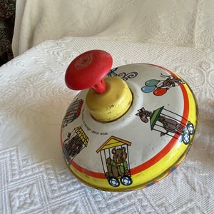 Vintage Ohio Art Co. Spinning Top Toy. Circus Train Cars Design with Red, Yellow and Blue Designs.