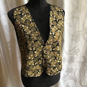 Vintage Beaded Leaf Vest. Arise 65 Cotton 35 Rayon Small Vest w/ Gold, Black Background. Size Small. Front 3 Snap Closure. Back Shaping Tie.