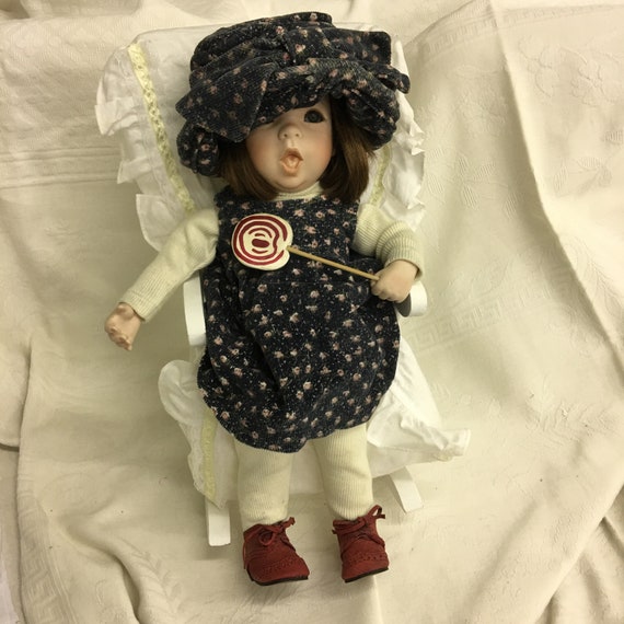 Vintage 1993 Little Girl Doll With Lolly Pop Sitting in a White