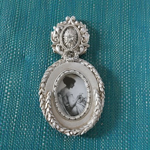 Victorian Style Silver Oval Frame with Laurel Wreath Design Around Edge. Wall Hanging Ornament to Hang Frame From. Charming.