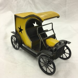 Vintage Replica Open Metal Car. Cut Out Star Designs and Curved Roof on This Yellow Metal Open Car.