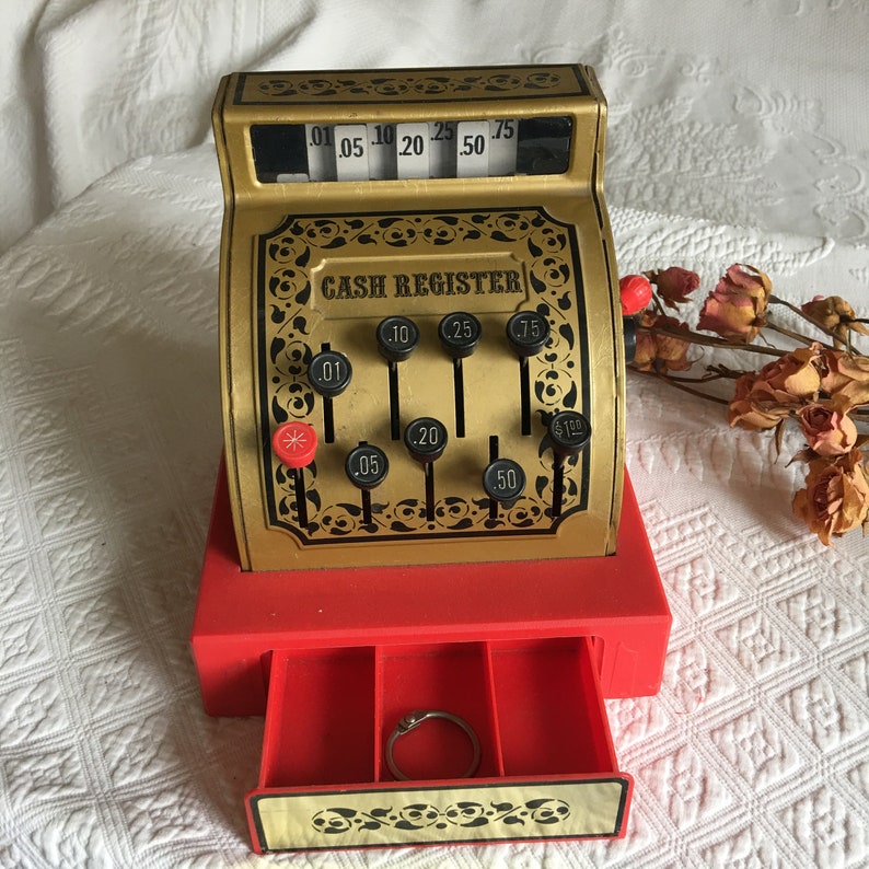 Gold With Black Print and Designs With Red Bottom Vintage Toy Cash Register Black and Red Plastic Handle Push Buttons to Raise Numbers.