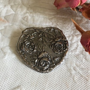 Vintage Large Scarf Ring. Choose Silver Tone Shield with Embossed Roses or Gold Tone Feather Circle Swirl. Clamping Ring on Back.