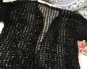 Vintage Black Shiny Thread Crocheted Jacket. Two Flower Rows Down Each Side of Front. Openwork Design on Body. Scalloped Edge. Ball Buttons.
