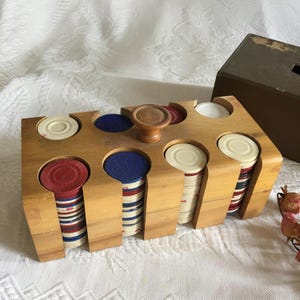 Vintage Poker Chips w drewnianym etui z twardą tekturową okładką. Czerwone, białe i niebieskie żetony Około 200 żetonów pokerowych w etui.