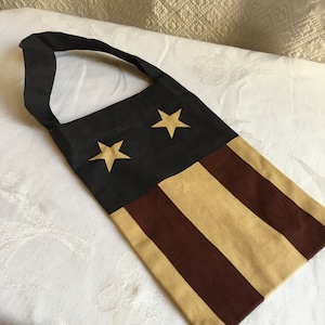 Americana Botton Tote Bag with Top Handle. Patriotic Design with White Stars on Blue Top and Red and White Stripe Bottom. Blue Handle.