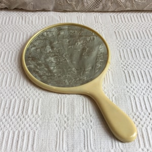 Vintage Celluloid Beveled Glass Hand Mirror. Round and Sturdy and Well Made in Yellow.