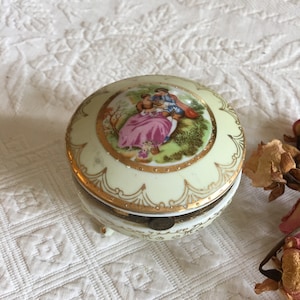 Vintage Romantic Dresser Box. Three Footed Box with Hinge. Courting Couple on Top with Gold Decorative Borders. Round Porcelain Jewelry Box.