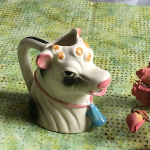 Vintage 1940s Ceramic Cow Head Cream Pitcher. Blue Bell Around Neck, Curly Hair in the Front. Holstein Cow. Fill at Top, Mouth is Spout.