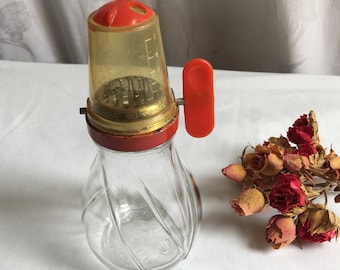 Vintage Nut Grinder with Measuring Cup on Top. Fill Jar with Nuts, Turn Over and Turn Red Handle to Grind Until Correct Measure.