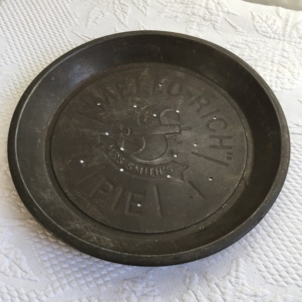 Vintage Mrs Smiths Mello Rich Pie Plate. Metal Pie Plate With Molded Mrs Smiths Mello Rich Pie. Vent Holes in Bottom. Dark with Age and Use.