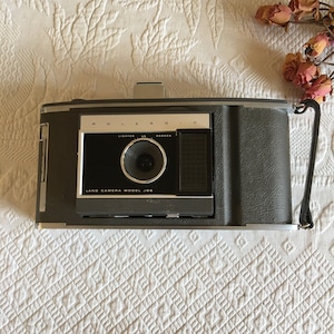 Vintage Polaroid Land Camera Model J66. Instruction Written on Back of Camera.