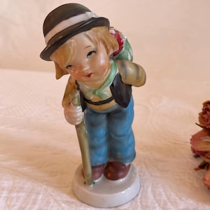 Vintage Porcelain Hiker Boy Figurine with Apples in Sack on His Back. Boy With Walking Stick, Black Vest and Hat.