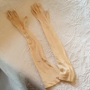 Vintage Long Nylon Dressy Gloves. Creamy Off-White Color w/ Two Button Snaps on Each. For Small Size. Decorative Stitching on Back of Hand.