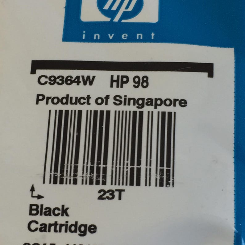 May include: An HP 98 black ink cartridge packaging featuring the HP invent logo in white on a blue background. The label displays the model number C9364W, the text Product of Singapore, a barcode, the code 23T, and the words Black Cartridge.