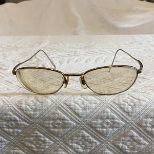 Vintage 1960s Wire Rim Eye Glasses in Gold. Ear Pieces Bend Slightly Toward Temples.