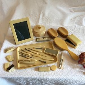 Vintage Celluloid Vanity Set. Tray, Frame, Hair Saver, 6 Brushes, Trinket Box, Comb, Mirror, Buffer, Containers, Fingernail Tools.