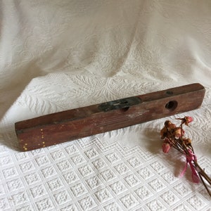 Antique Wooden Level. Carpenters Level of Wood and Metal With Clear Liquid Bubble for Horizontal Leveling.