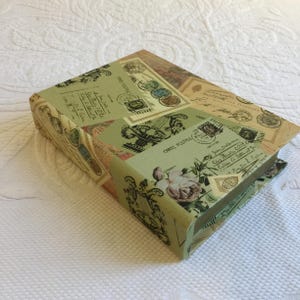 Caja de libros vintage con almacenamiento oculto. Cartas y postales antiguas impresas en tapa dura. Úsala como base de exhibición y para guardar artículos en su interior.
