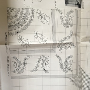 May include: A black and white placement chart for a quilt pattern. The chart shows a grid with a design of leaves and curved lines. The text "PLACEMENT CHART ONE-FOURTH SHOWN" is on the left side of the chart.