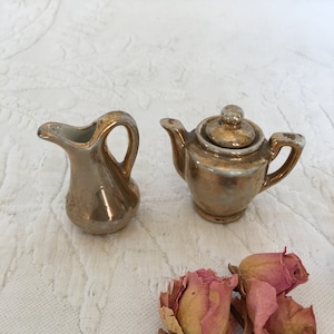 Vintage Miniature Porcelain Teapot and Pitcher. White Porcelain With Gold On Top. An iridescent Glow From Mixture of White and Gold Surface.
