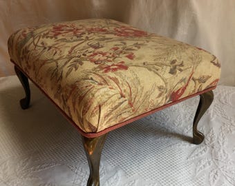Vintage Footstool w/ Brass Legs. Bark Cloth Type Rose and Leaf Print in Cream, Soft Pink and Green with Old Fashioned Pink Corded Edge.
