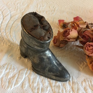 Antique Metal Pin Cushion. Roll Down Boot With Pointed Toe Wood Chip Filled Black Fabric Pin Cushion. Charming, Worn Collectible.