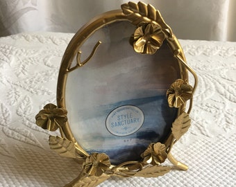 Gold Tone Dimensional Frame with Its Own Stand. Leaves, Flowers and Branches Decorate This Oval Frame. Charming.