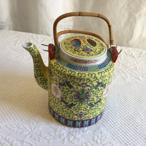 Vintage Chinese Hand Painted Teapot with Flowers, Leaves and Swirls. Yellow Background with Green and Red. Wicker Wrapped Wire Handles.