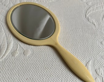 Vintage Creamy Celluloid Hand Mirror. Beveled Oval Double Glass Dresser Hand Mirror. Heavy and Well Made.